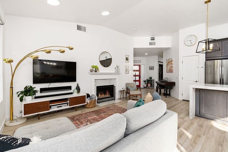 Modern living room featuring a cozy fireplace, sectional sofa, and stylish decor.