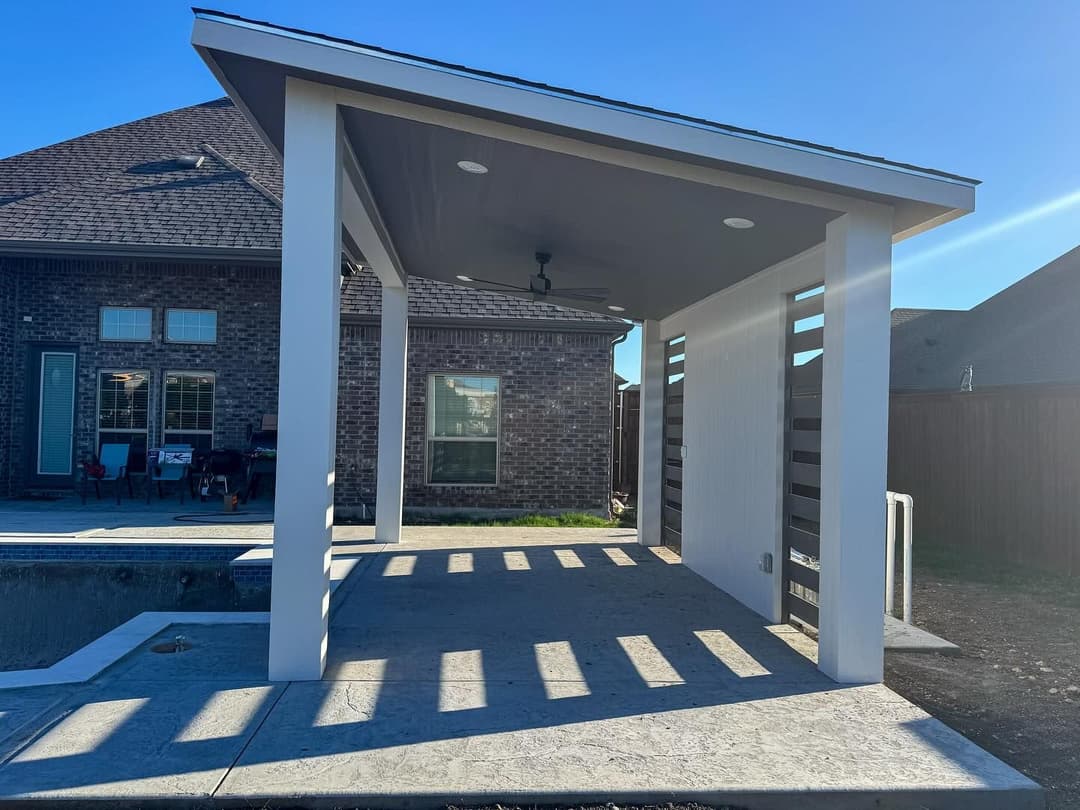 Modern outdoor patio with ceiling fan, designed for relaxation and entertaining near a home.