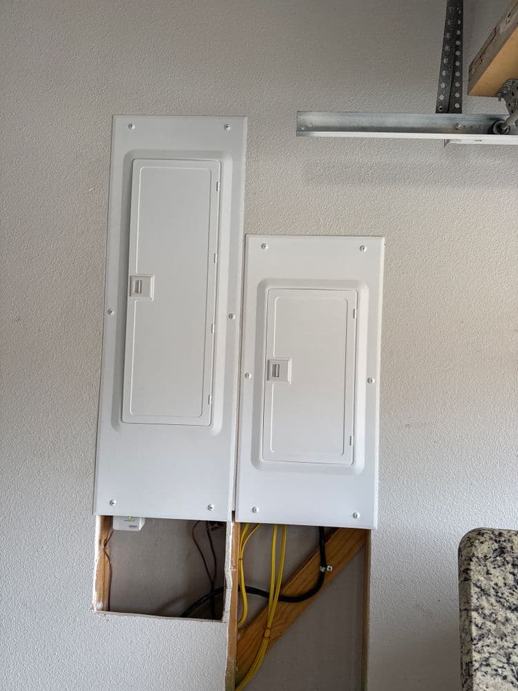 Electrical junction boxes mounted on a wall with visible cables and wooden framing.